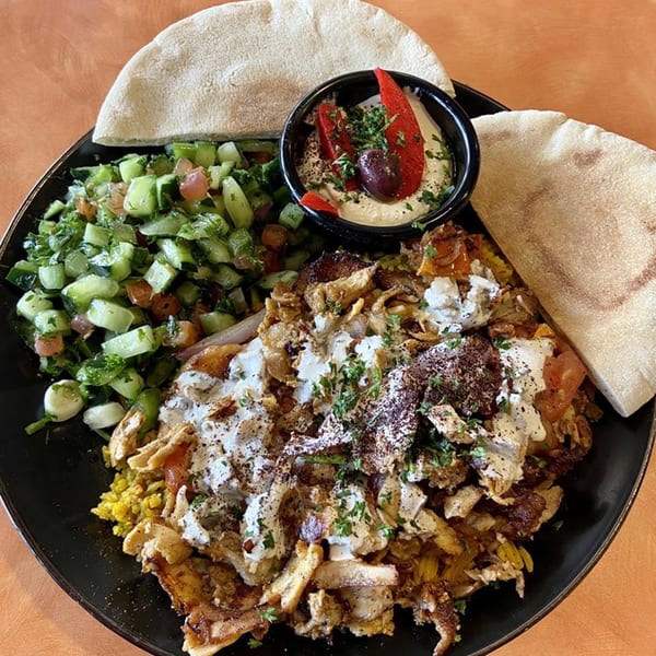 Falafel Hut's Mediterranean platter with shawarma, rice, salad, hummus, and pita bread.